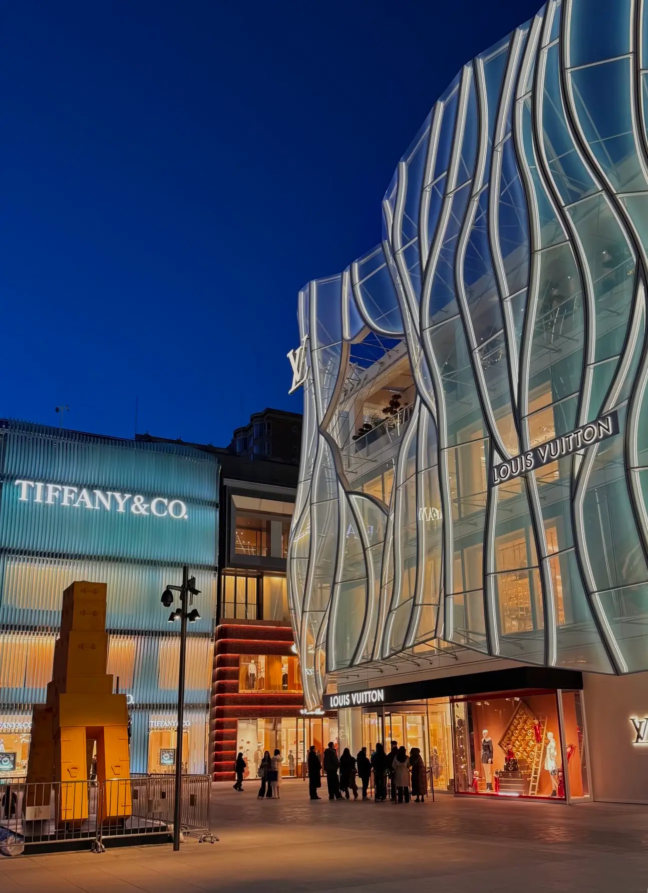Luxury storefronts including Louis Vuitton and Tiffany & Co. at Sanlitun Taikoo Li in Beijing, showcasing high-end Beijing shopping and modern architectural design.