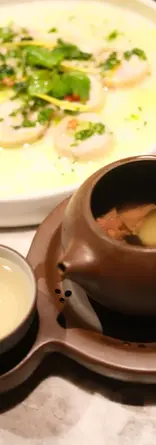 Traditional nourishing soup served in a teapot-style vessel during the Bite Escape TCM tour dinner.