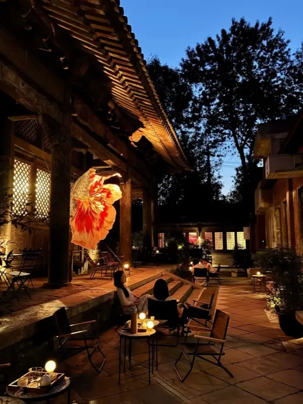 Evening courtyard at Temple Dongjingyuan with soft lights and outdoor seating