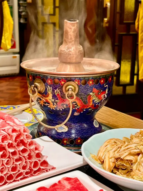 Traditional copper pot and fresh sliced lamb at Nanmen Shuanrou.