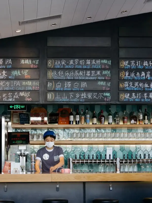Beer taps and menu board inside Slow Boat Brewery Beijing