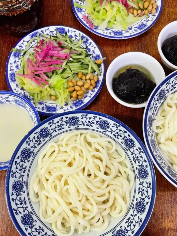 Zhajiangmian served with traditional side dishes and toppings