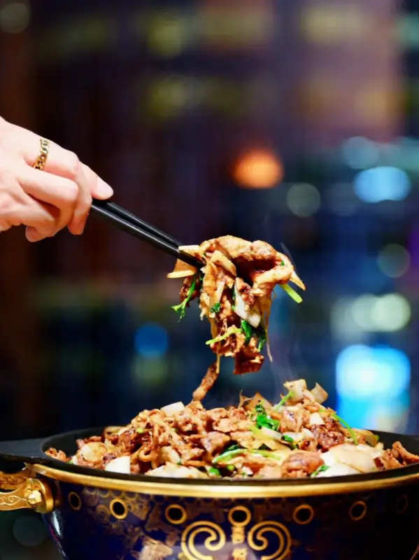 Grilled meat lifted from the copper pan during zhizi kaorou