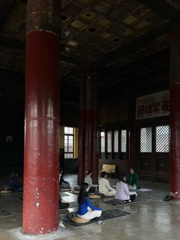 Participants meditating inside a quiet hall at Temple Dongjingyuan
