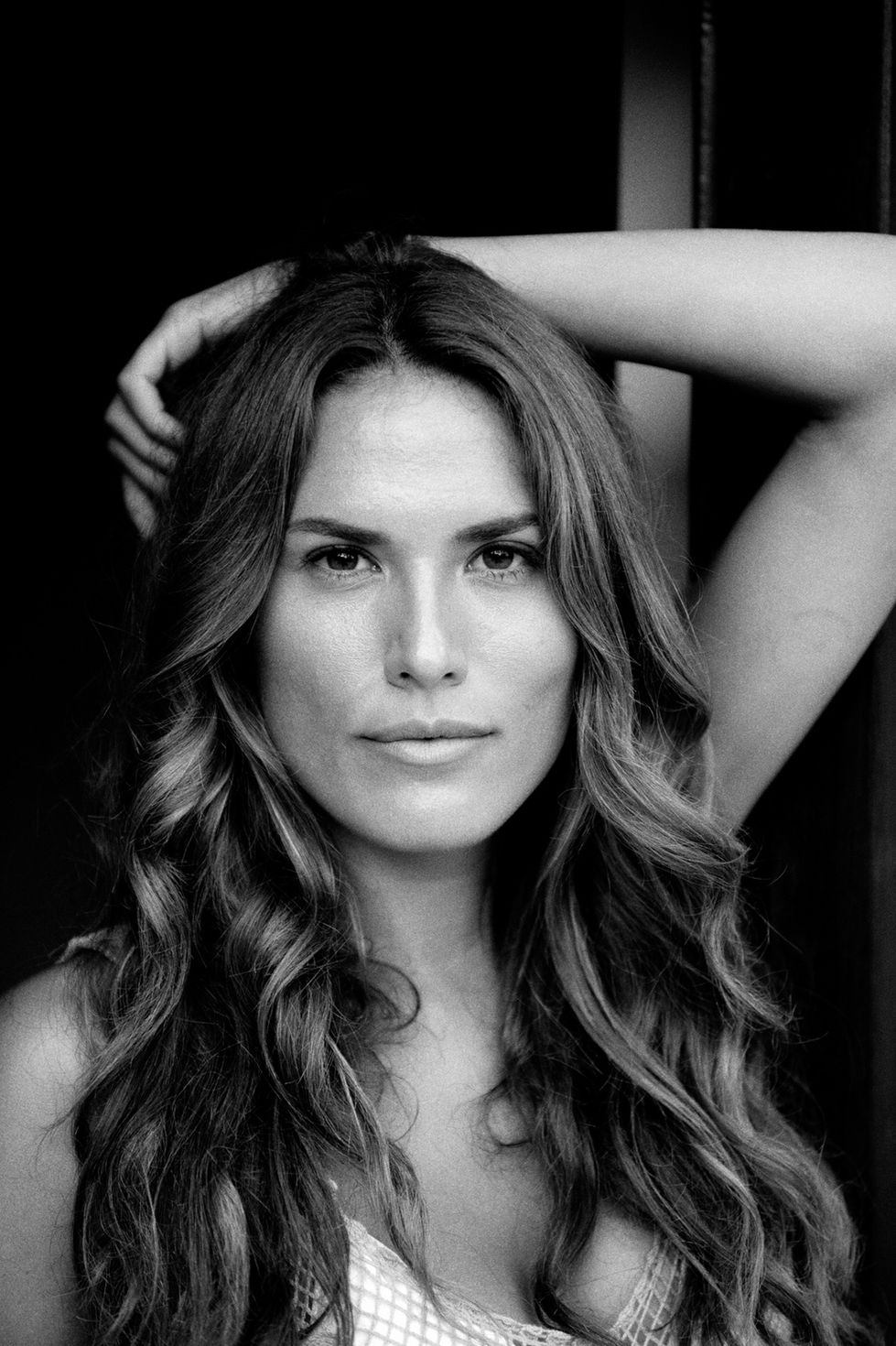 a black and white photo of a woman with long hair