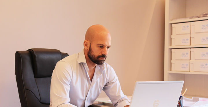 Uomo in ufficio che lavora al computer portatile