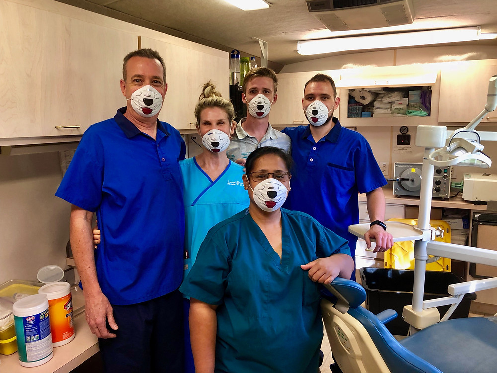 Dr. Jim (left) with wife Nicole and sons Matt and Tom works in our mobile dental clinic with local dental assistant Yumi