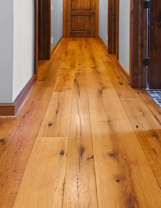 Perspective view of a long hallway featuring a professional installation of Resawn Oak.