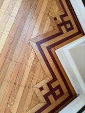 Historic oak plank flooring restoration with custom walnut parquet border in a luxury Short Hills NJ residence, featuring antique wood floors, detailed craftsmanship, and timeless architectural character.