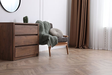 Herringbone wood floor in a clean, modern living room