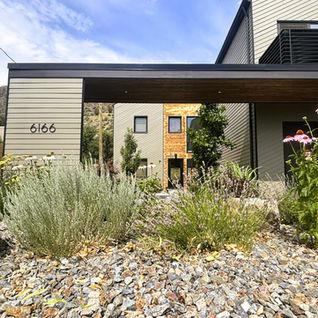 Modern house exterior with xeriscape garden and number 6166.