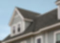 Gray shingle roof and dormer windows on light blue house.