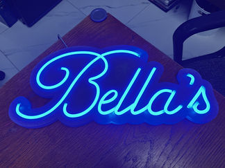Blue neon sign spelling Bella's