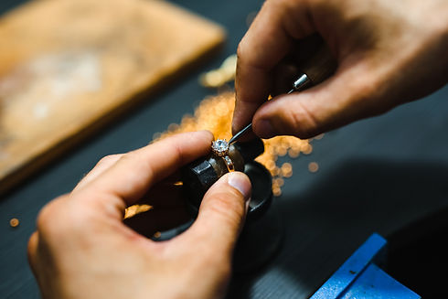 Hands grinding metal, sparks flying.