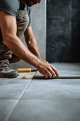 Man tiling floor