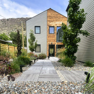 Modern two-story house with wood and grey siding.