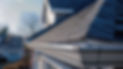 Close-up of a clean metal eavestrough on a shingle roof