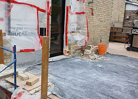 Exterior home renovation showing window installation prep