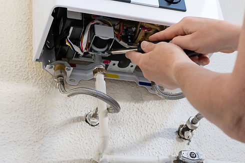 Technician repairing the interior of a tankless water heater