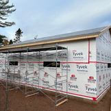 Building under construction, Tyvek HomeWrap DUPONT, with metal scaffolding.