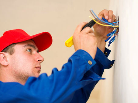 A technician installing electricity in a new house.