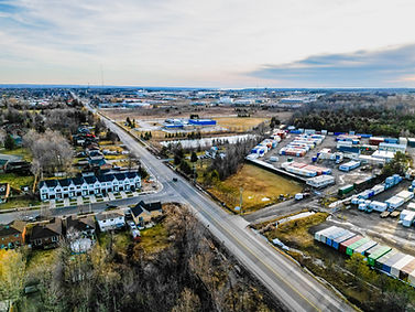 Aerial view of road, houses, and storage containers