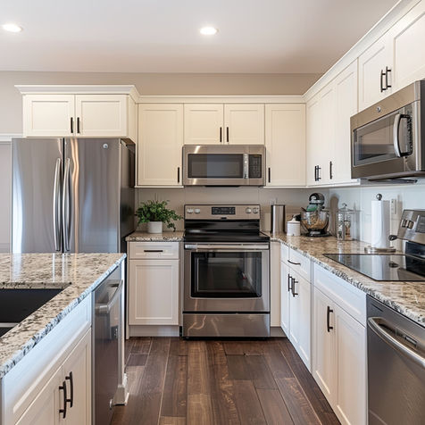 Kitchen with white cabinets, stainless steel, and granite counters.
