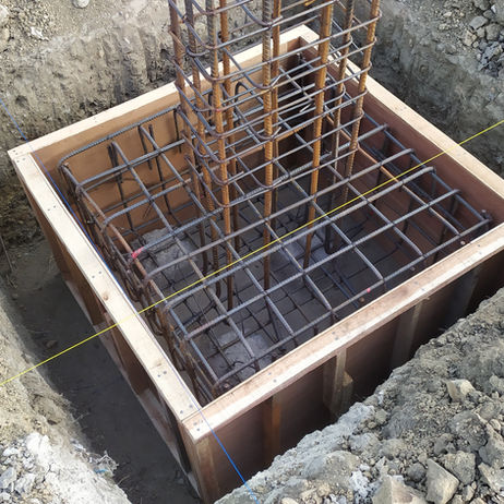Square concrete pile cap with central rebar cage.