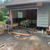 Construction site, worker building building, with disassembled garage. General Contracting is occurring.