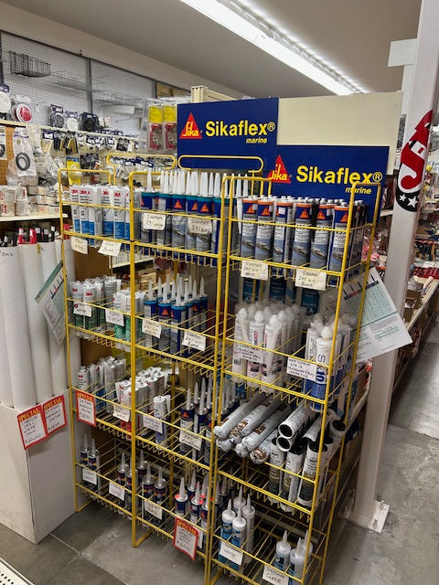 Sikaflex sealant products on a yellow display stand