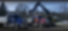 Volvo excavator loading two dump trucks