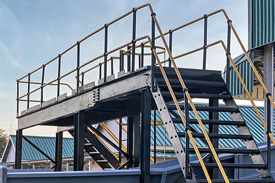 Steel industrial platform with safety handrails and stairs