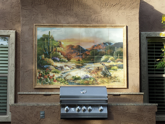 Outdoor kitchen with built-in grill and desert painting