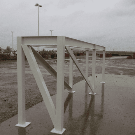 Large white steel fabrication frame structure outdoors