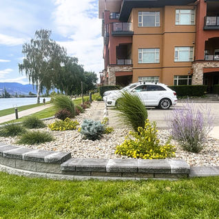 Lakeside landscaping project with stone retaining wall.