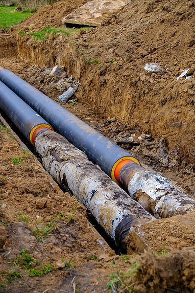 Old and new pipes in a trench