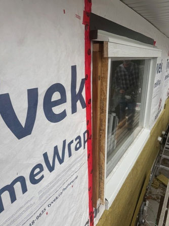 Building exterior with new window installation and Tyvek HomeWrap