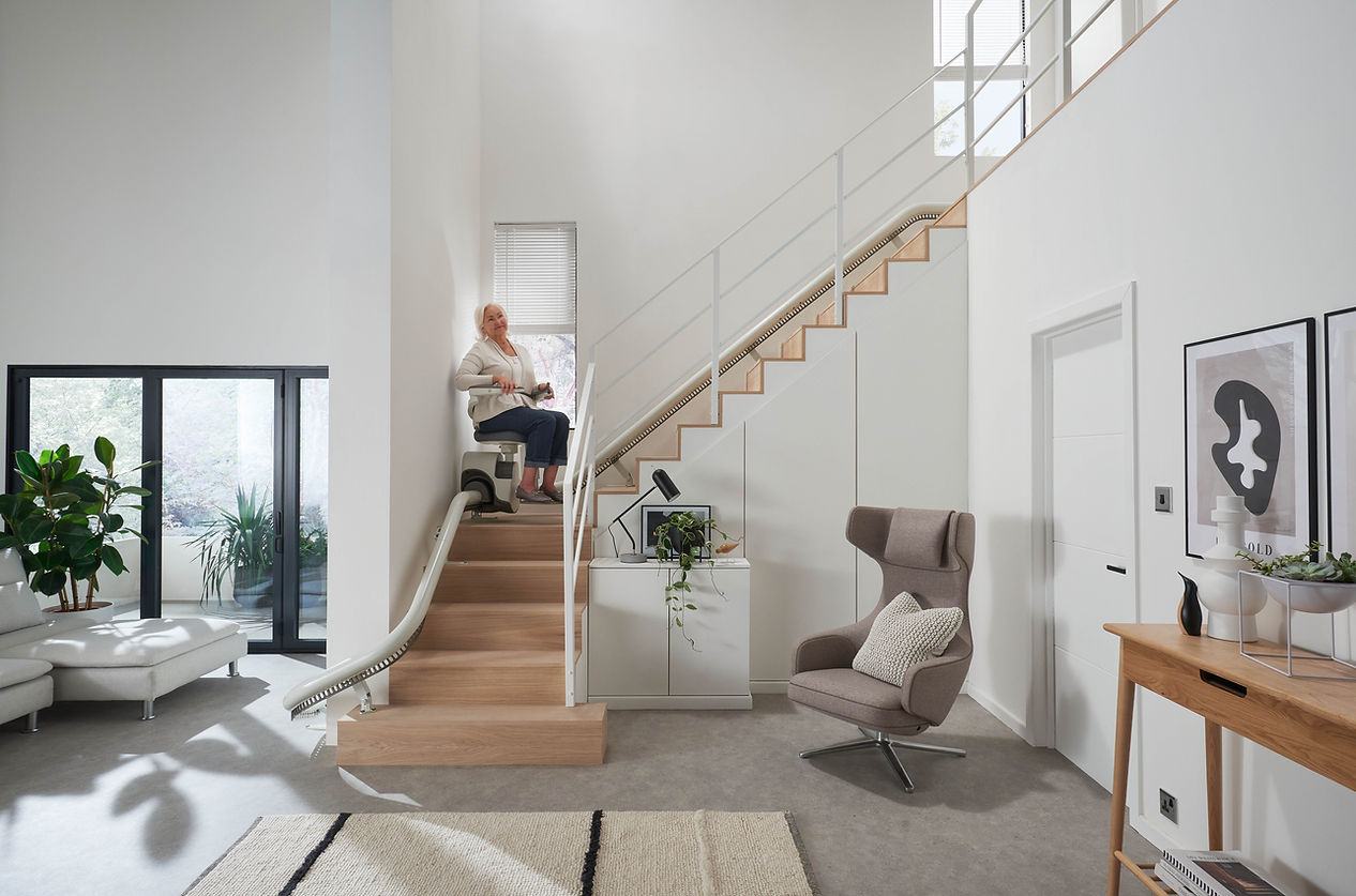 Woman using stairlift in living room area