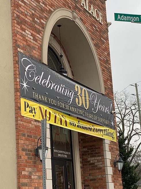 Building with 'Celebrating 30 Years' and 'Pay No Tax' signs