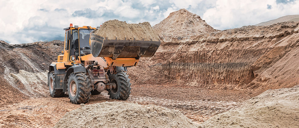 Yellow loader moving earth at a civil works site