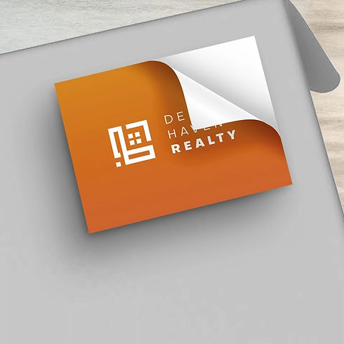 Orange sticker with DE HA REALTY logo and text, peeling at corner