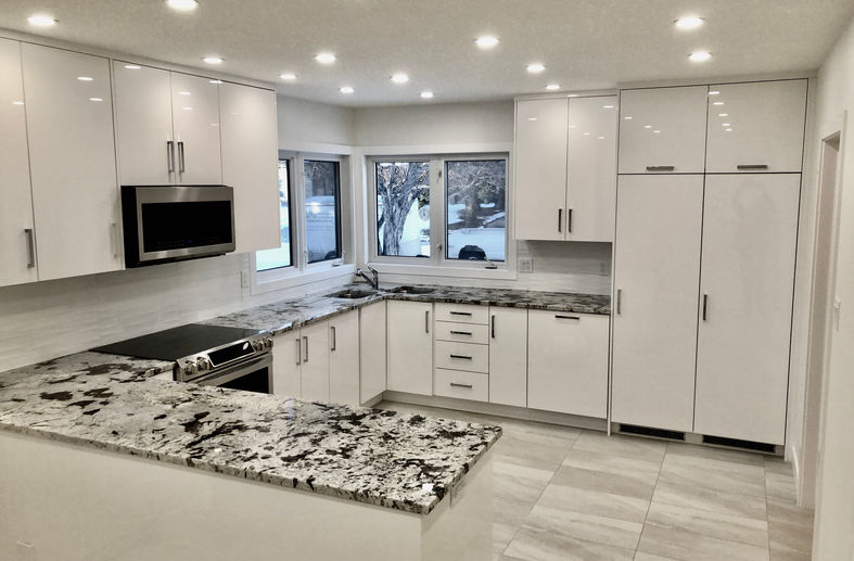 Modern white kitchen with marble counters