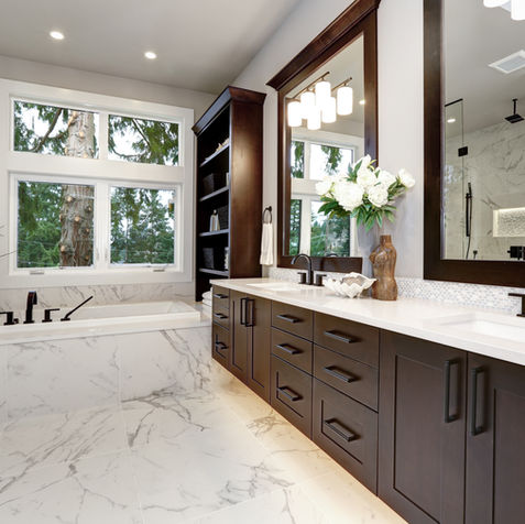 Luxury bathroom with marble, dark wood double vanity, large tub