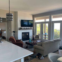 Cozy living room with fireplace, TV, and outdoor access, suites and additions.