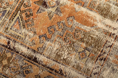 Distressed vintage geometric pattern carpet with earthy faded colors