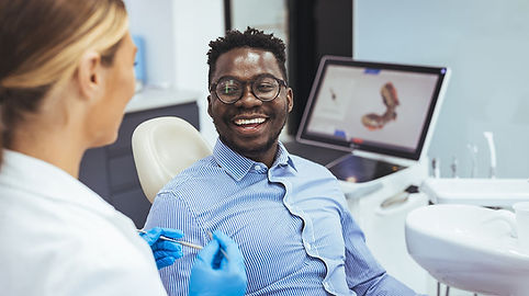 Smiling patient during a general dentistry consultation.