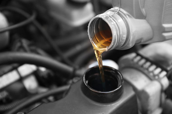 Pouring engine oil into a car engine