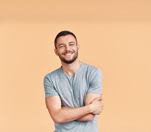 Happy smiling handsome man with crossed arms looking to camera