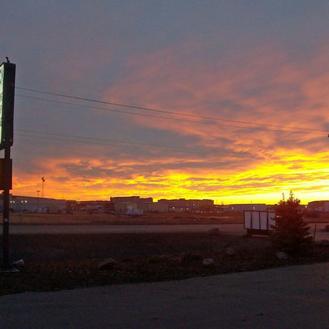 Sunset over a steel fabrication facility skyline.