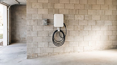 EV charger installation on a concrete block garage wall.